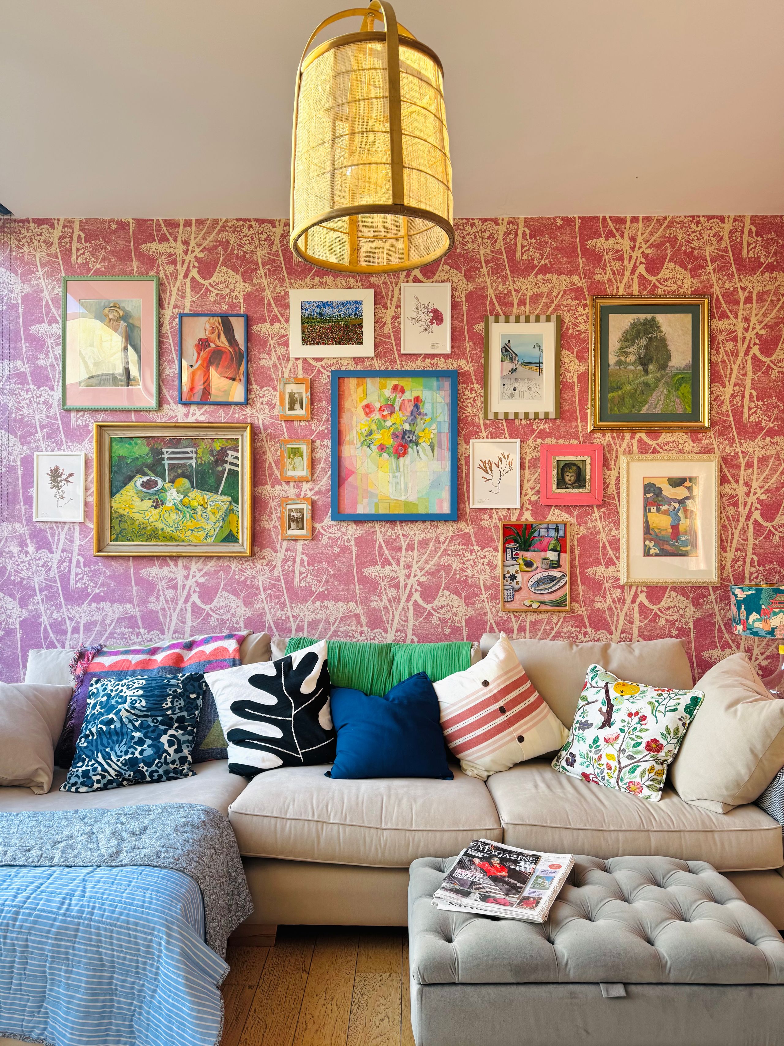 Image may contain: Home Decor, Cushion, Lamp, Art, Painting, Book, Publication, Couch, Furniture, Person, Pillow, and Indoors