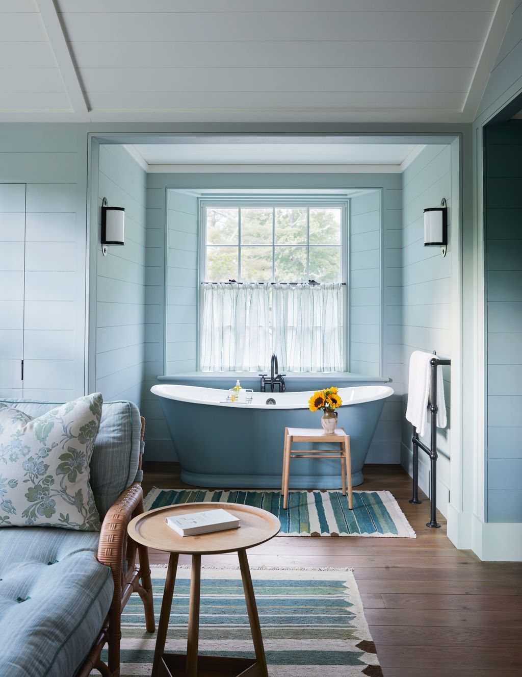 Image may contain Home Decor Book Publication Indoors Interior Design Bathing Bathtub Person Tub Rug and Lamp