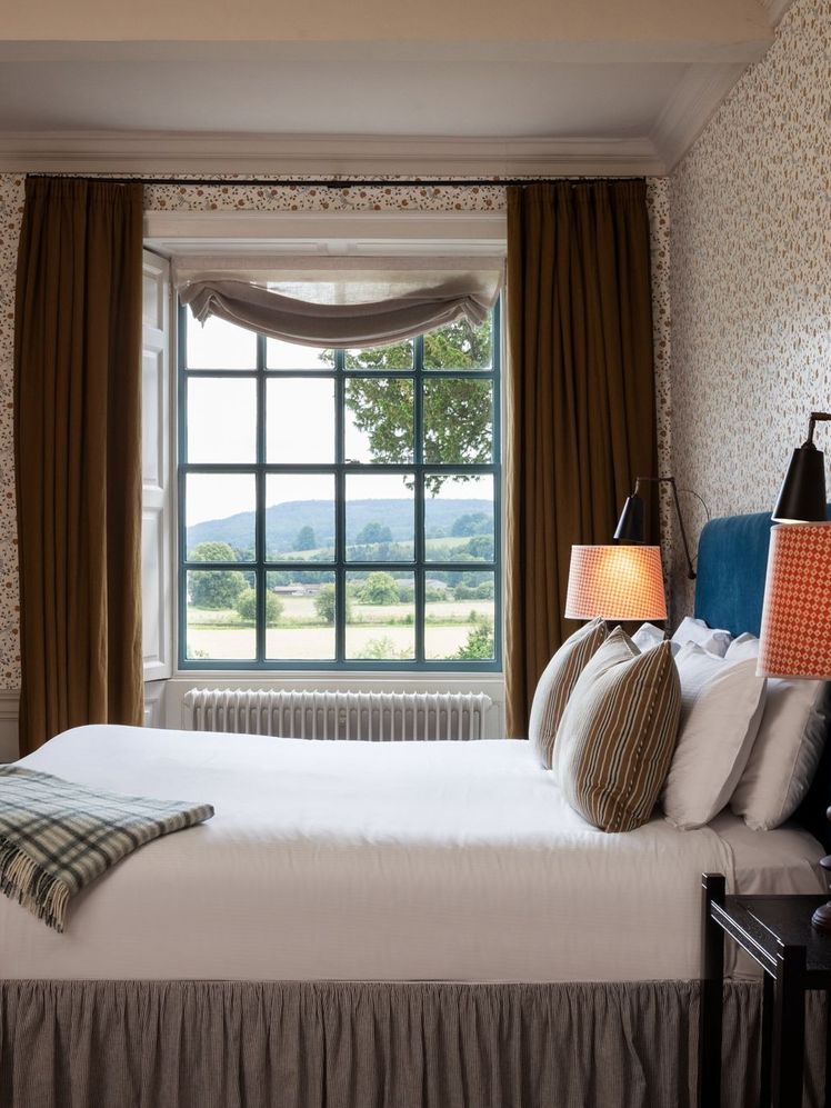 Image may contain Lamp Art Painting Bed Furniture Window Table Lamp Indoors Interior Design Chair and Bay Window