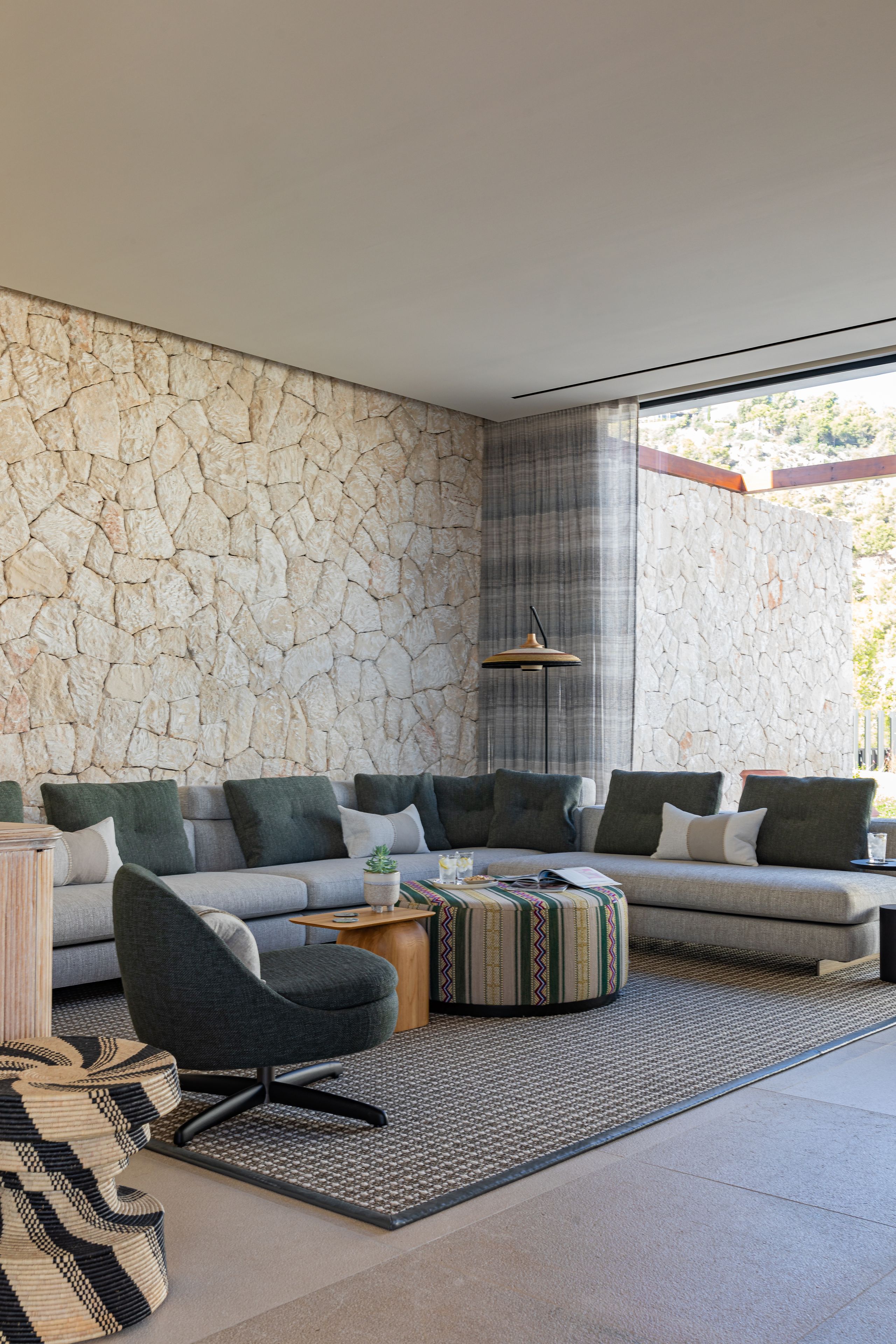 Image may contain: Home Decor, Plant, Lamp, Indoors, Interior Design, Couch, Furniture, Rug, Chair, Table, and Architecture