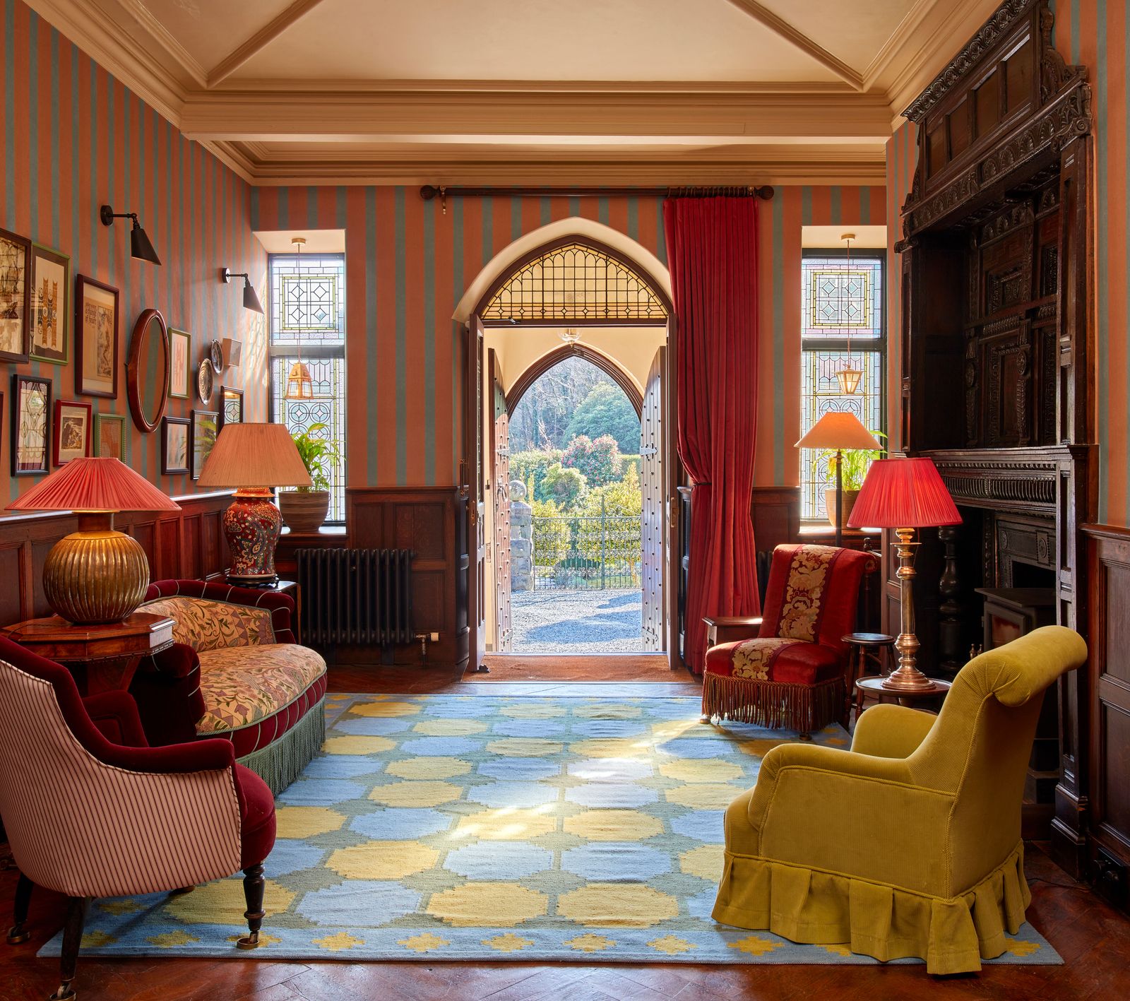 Image may contain Home Decor Lamp Chair Furniture Plant Architecture Building Indoors Living Room Room and Rug