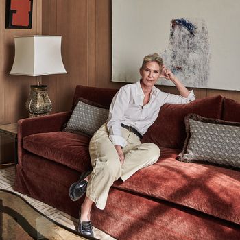 Image may contain: Person, Sitting, Couch, Furniture, Lamp, Accessories, Belt, Adult, Clothing, Footwear, Shoe, and High Heel