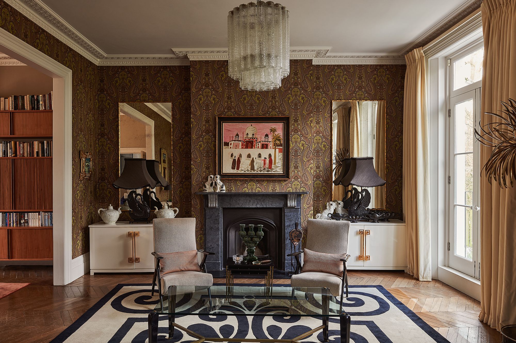 Image may contain: Home Decor, Lamp, Chair, Furniture, Art, Painting, Rug, Indoors, Interior Design, and Architecture