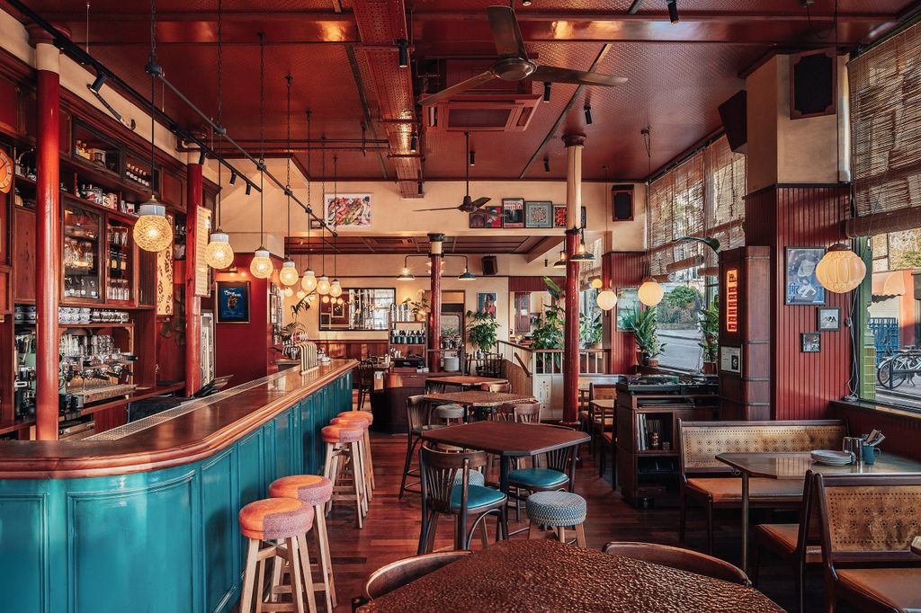 Image may contain Desk Furniture Table Bar Chair Bench Art Painting Plant Lamp Bicycle and Transportation