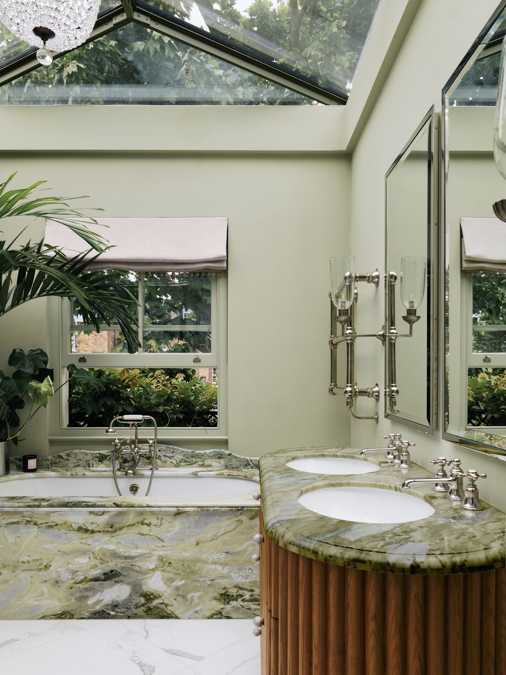 Image may contain Sink Bathing Bathtub Person Tub Sink Faucet Window and Lamp