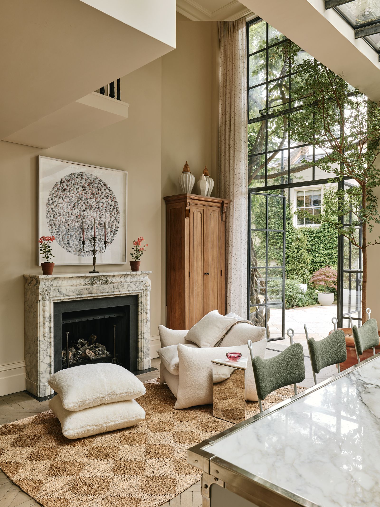 Image may contain Home Decor Fireplace Indoors Desk Furniture Table Chair Rug Couch Art Painting and Plant