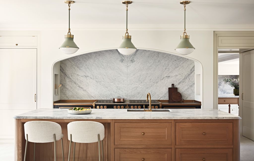 Image may contain Indoors Interior Design Kitchen Kitchen Island Chair Furniture Sink Sink Faucet and Cooktop