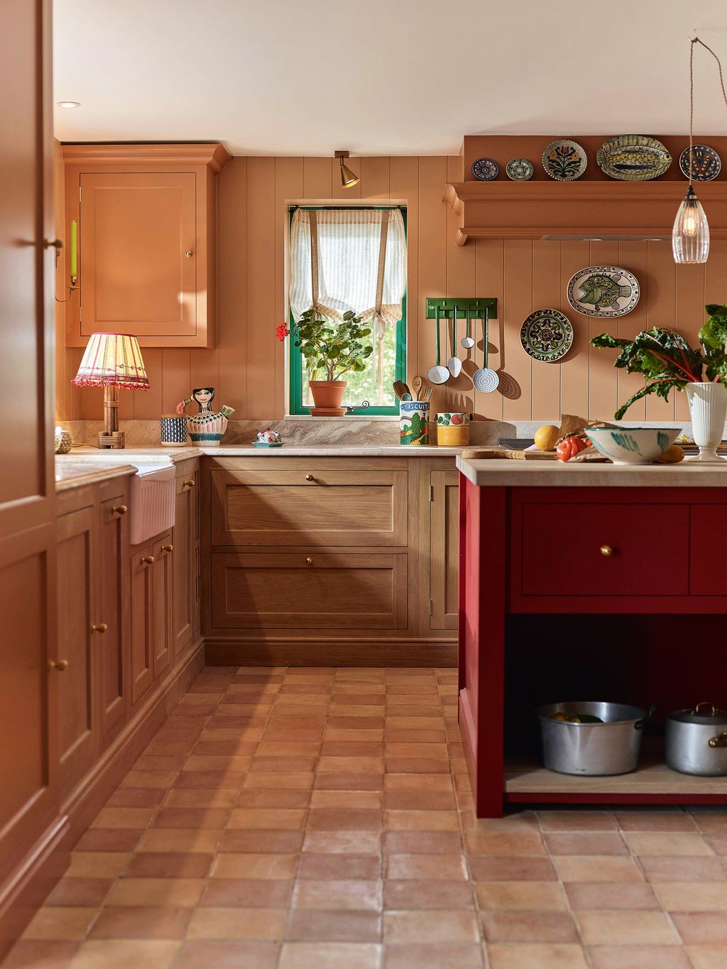 Image may contain Floor Indoors Interior Design Flooring Kitchen Plant Lamp Plate Person and Cup
