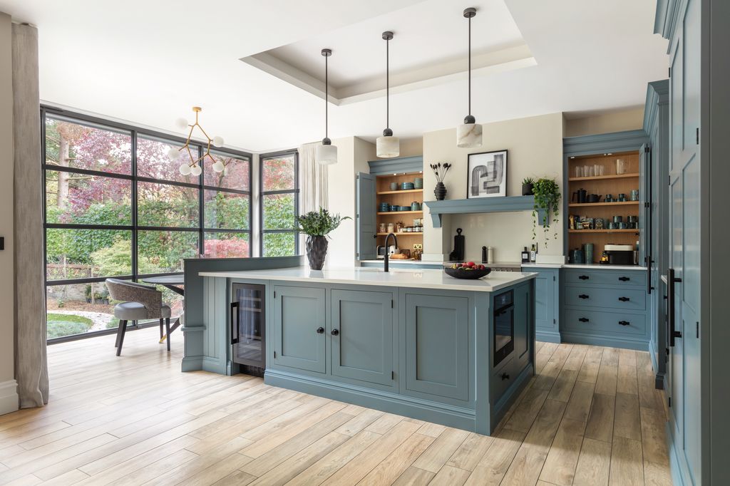 Image may contain Indoors Interior Design Kitchen Kitchen Island Plant Chair Furniture Art Painting and Sink