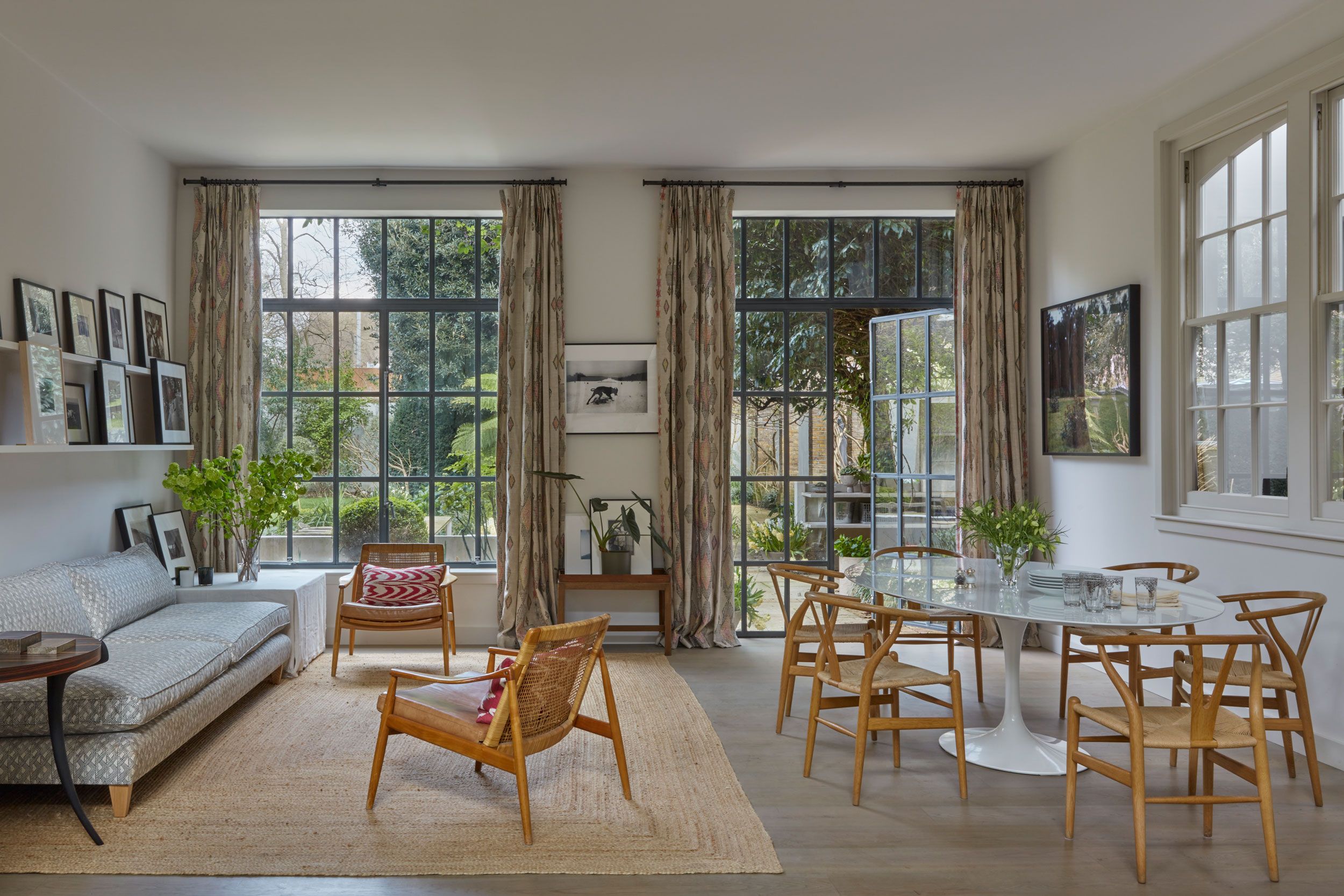 Image may contain: French Window, Window, Chair, Furniture, Home Decor, Rug, Art, Painting, Couch, Plant, Table, and Desk