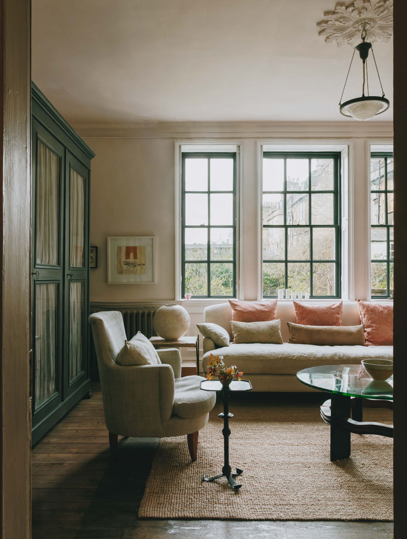 Image may contain Window Home Decor Rug Couch Furniture Art Painting Chair French Window Bay Window and Desk