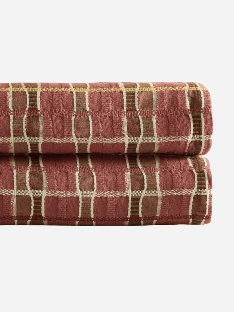 Image may contain: Bath Towel, Towel, Couch, and Furniture