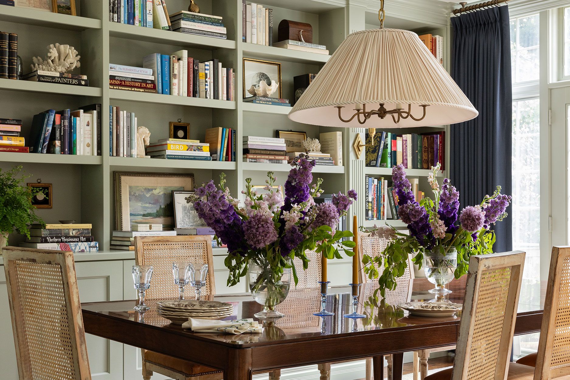 Image may contain: Furniture, Table, Architecture, Building, Dining Room, Dining Table, Indoors, Room, Lamp, Chair, and Art