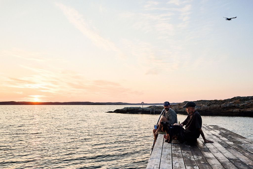 Image may contain Water Waterfront Nature Outdoors Sky Port Scenery Clothing Hat Adult Person and Photography