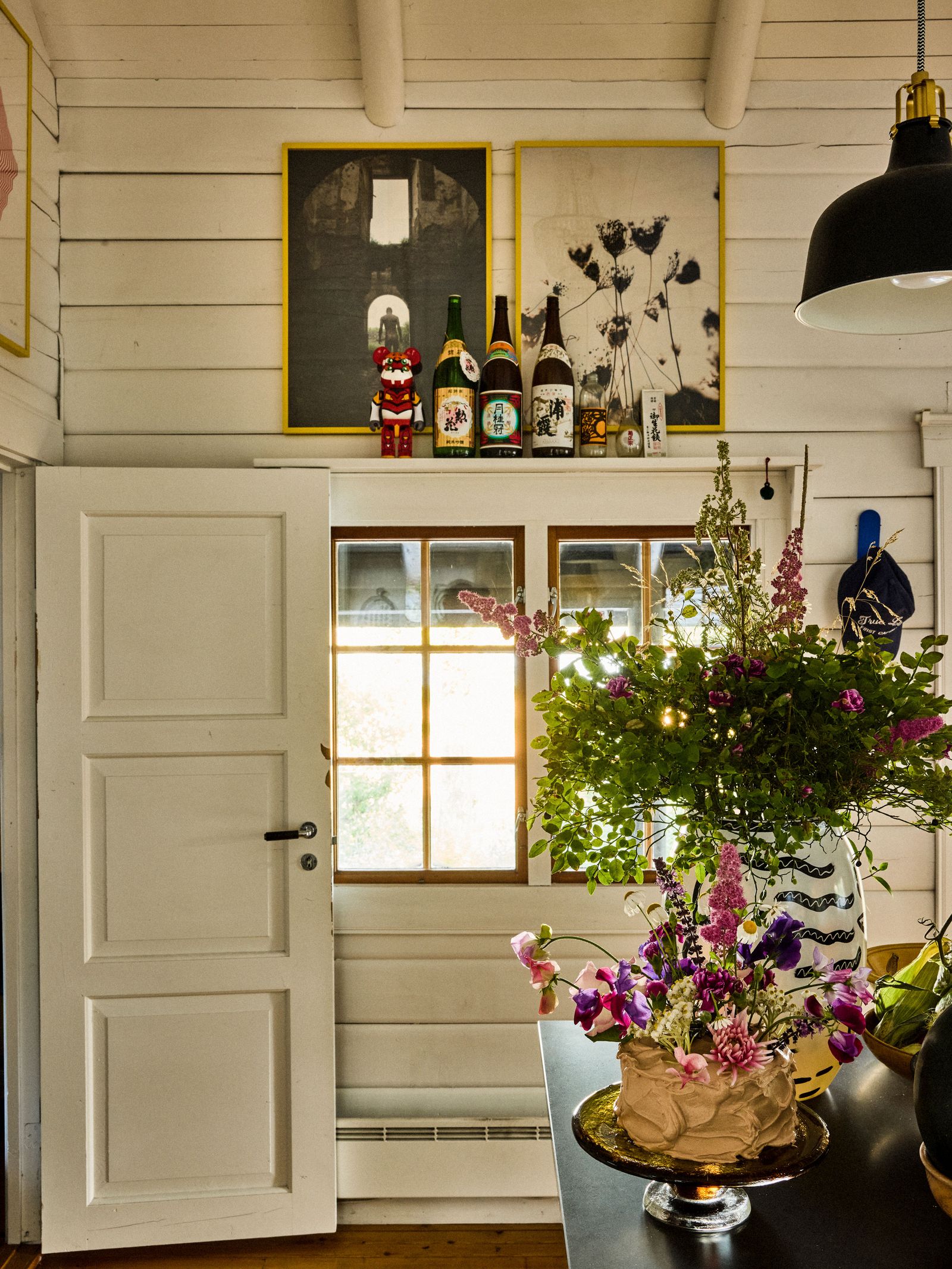 Image may contain Plant Potted Plant Flower Flower Arrangement Lamp Indoors Interior Design Flower Bouquet and Door