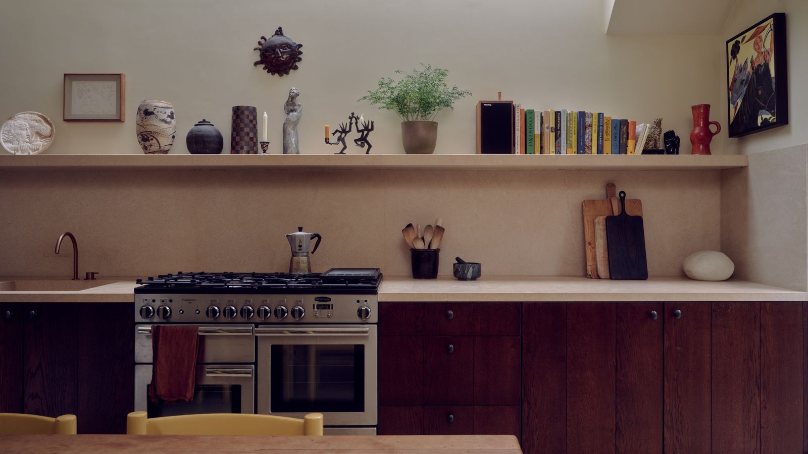 Image may contain Indoors Interior Design Chair Furniture Kitchen Plant Cooktop Person Art Painting Cup and Sink