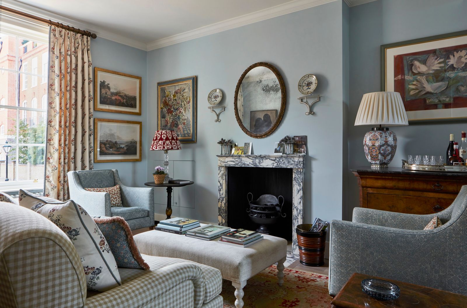 Image may contain Home Decor Lamp Architecture Building Furniture Indoors Living Room Room Art Painting and Couch