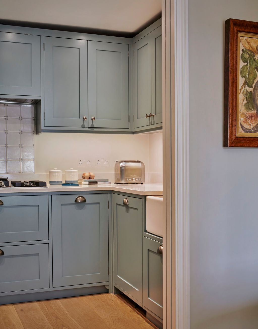 Image may contain Indoors Interior Design Kitchen Cooktop Sink Sink Faucet Art Painting and Furniture