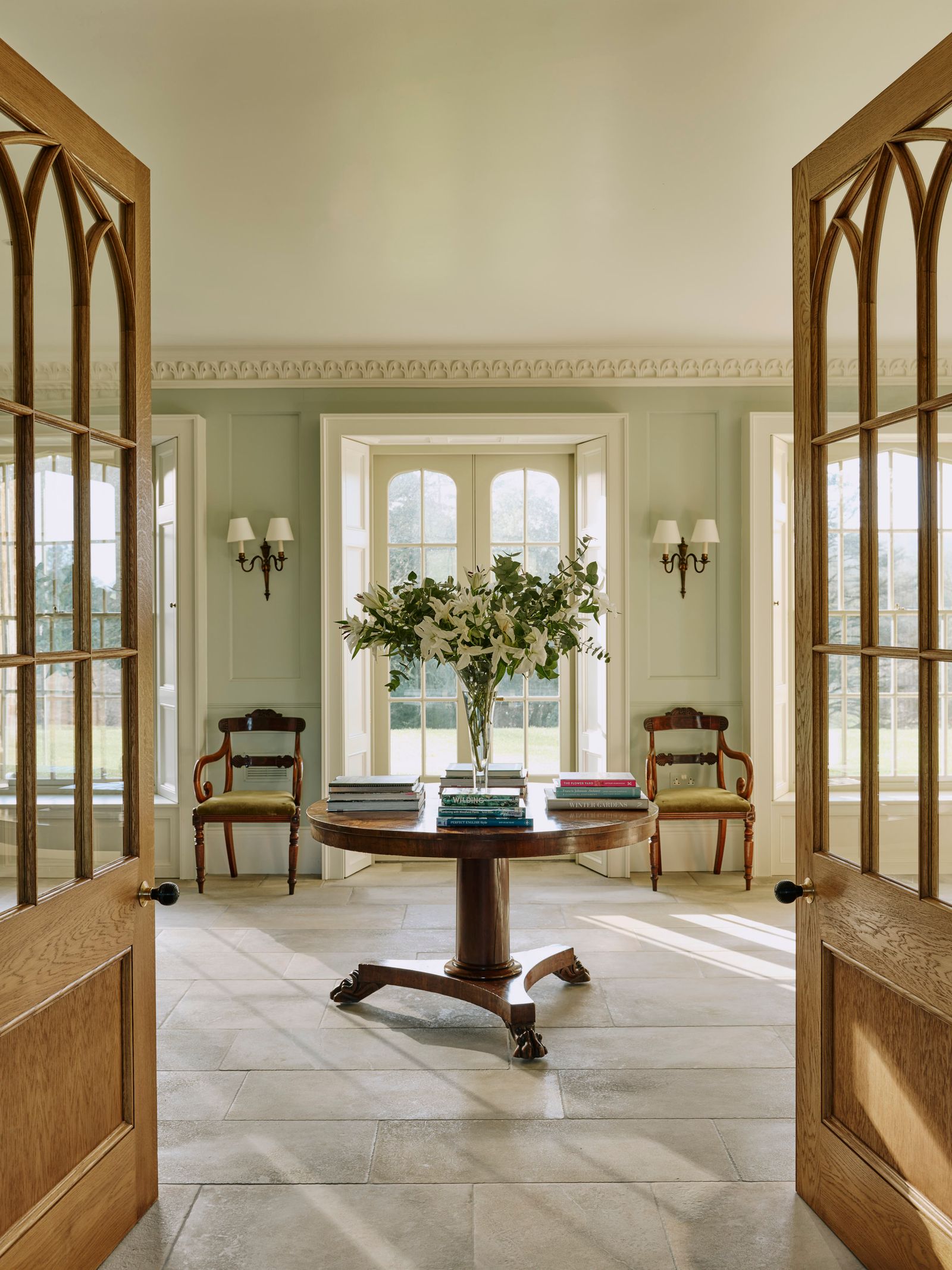 Image may contain Floor Desk Furniture Table Chair Lamp Door Architecture Building Foyer Indoors and Flooring