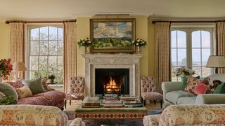 Image may contain Home Decor Fireplace Indoors Chair Furniture Lamp Couch Art Painting Architecture and Building