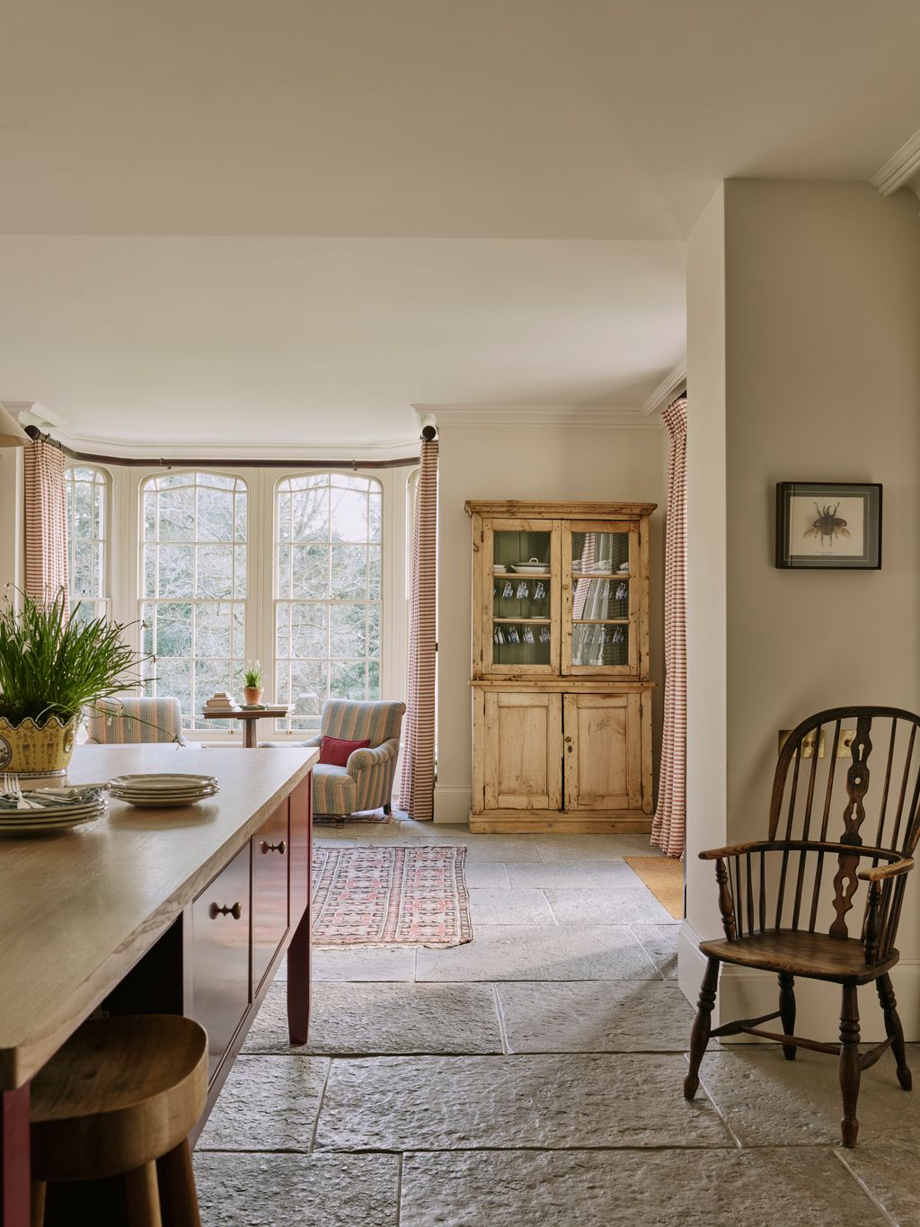 Image may contain Floor Chair Furniture Plant Home Decor Indoors Interior Design Rug Window and Flooring