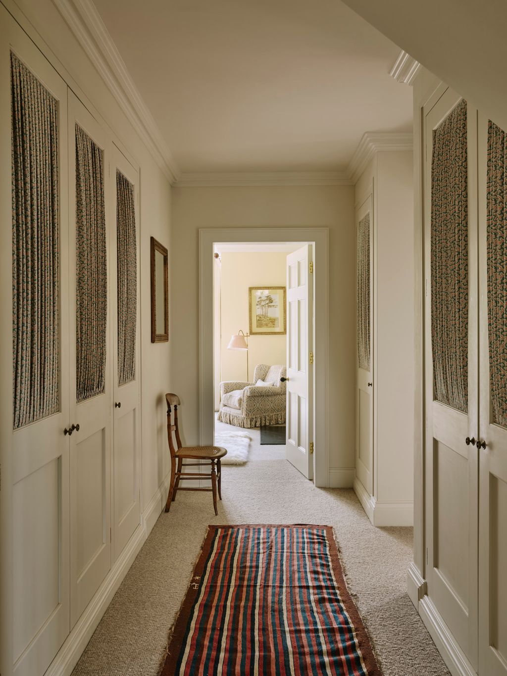 Image may contain Indoors Home Decor Rug Art Painting Chair Furniture Interior Design Hallway Couch and Lamp