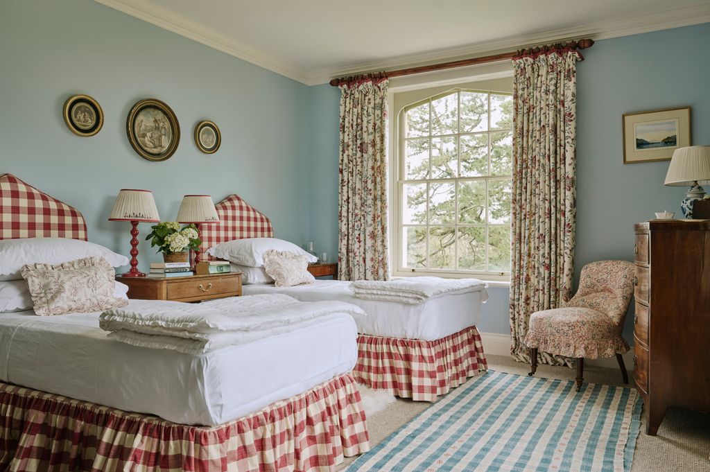 Image may contain Lamp Home Decor Chair Furniture Rug Art Painting Table Lamp Bed Cushion and Window