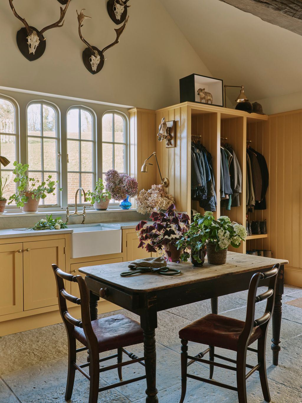 Image may contain Chair Furniture Indoors Interior Design Desk Table Lamp Plant Dining Table and Architecture