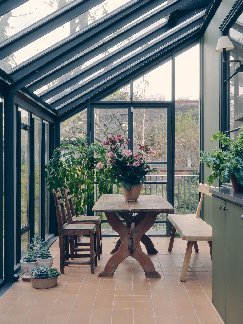 Image may contain Desk Furniture Table Garden Nature Outdoors Floor Chair Plant Lamp Window and Dining Table