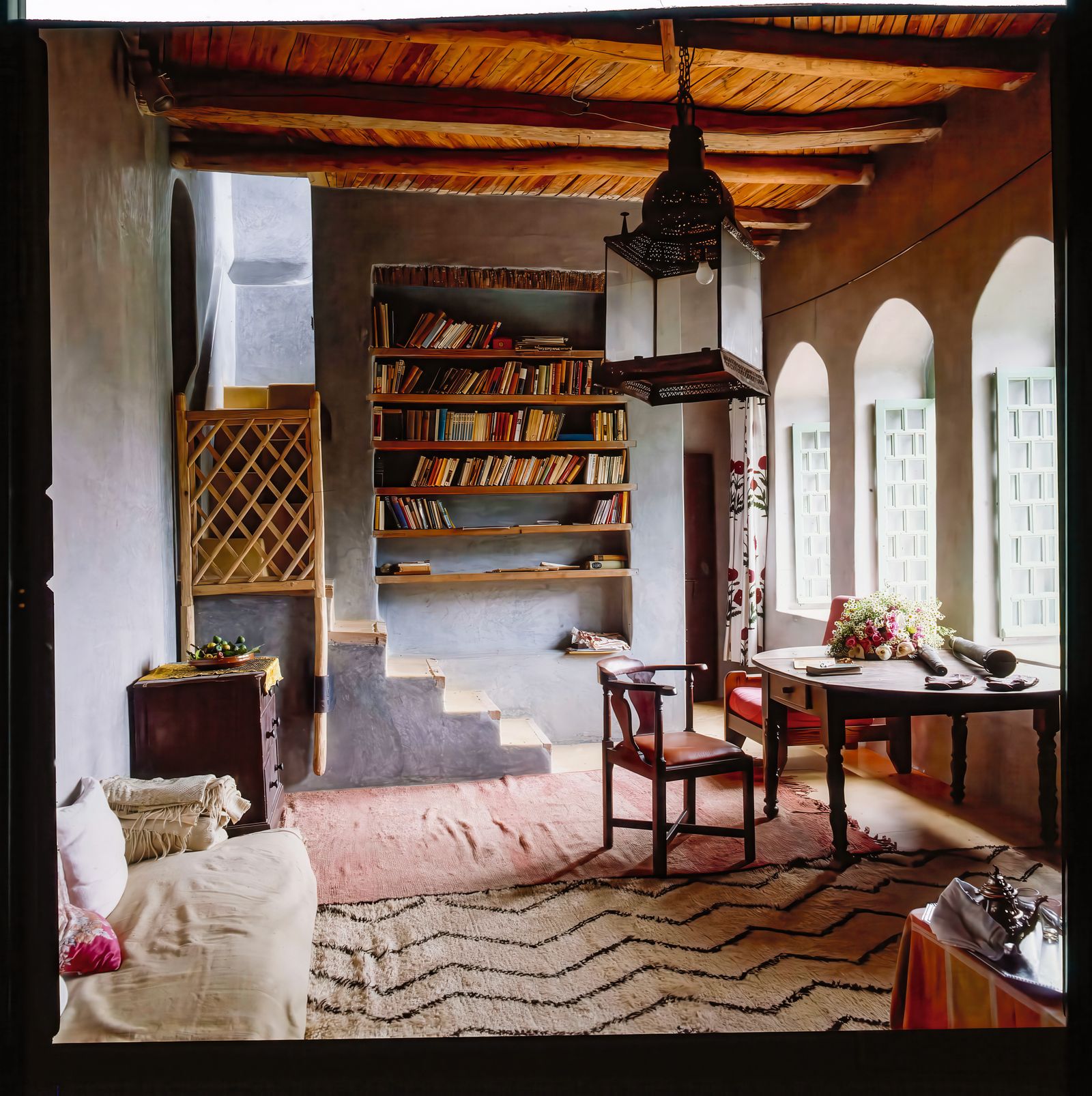 Image may contain Architecture Building Furniture Indoors Living Room Room Interior Design Desk Table and Chair