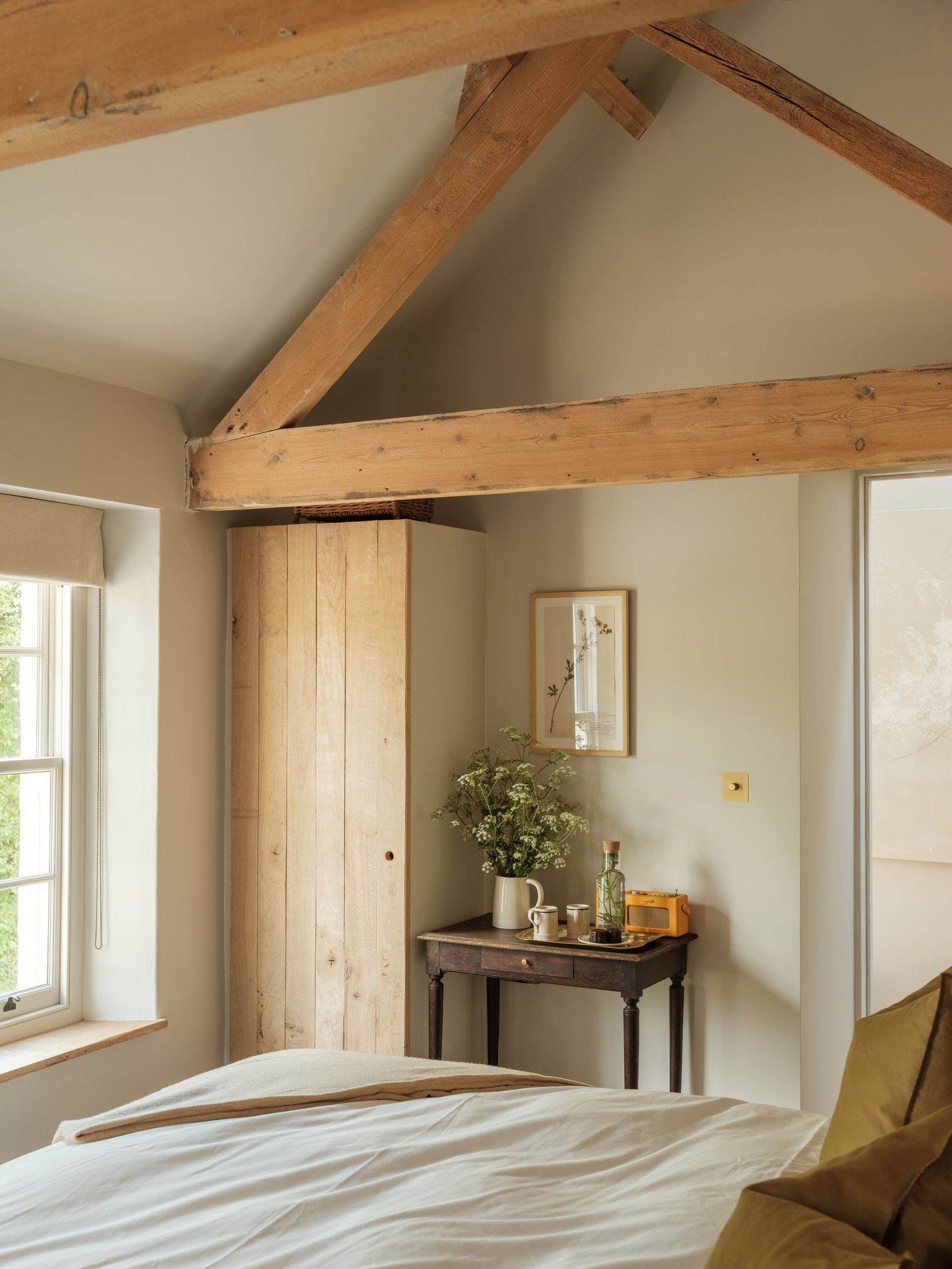 Image may contain Indoors Interior Design Desk Furniture Table Wood Cup Bed Corner Art Painting and Door