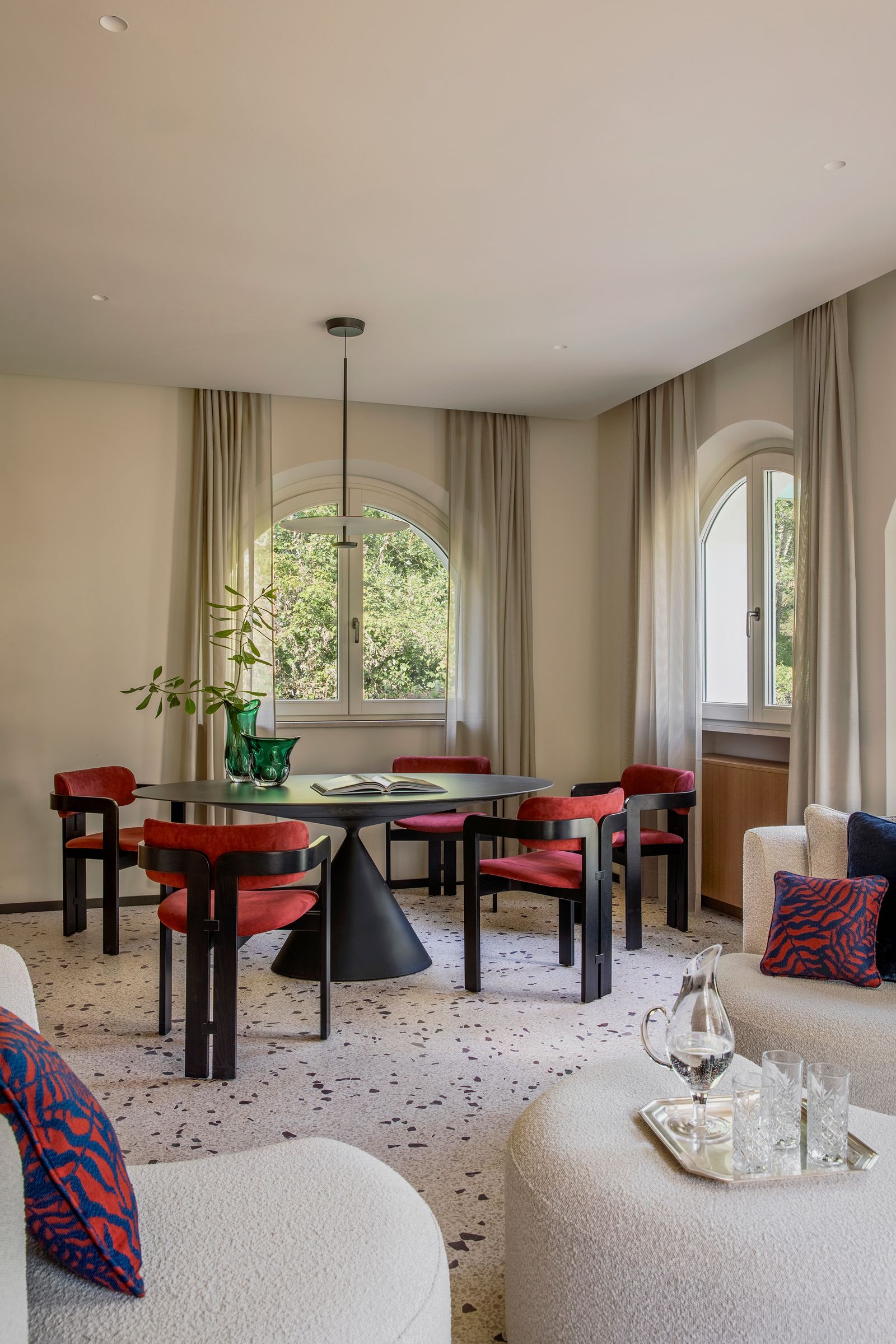 Image may contain Home Decor Chair Furniture Desk Table Cup Plant Dining Table Book Publication Lamp and Couch