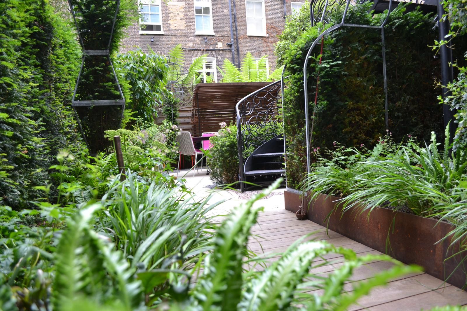 Image may contain: Garden, Nature, Outdoors, Backyard, Yard, Plant, Vegetation, Chair, Furniture, City, Arbour, and Grass