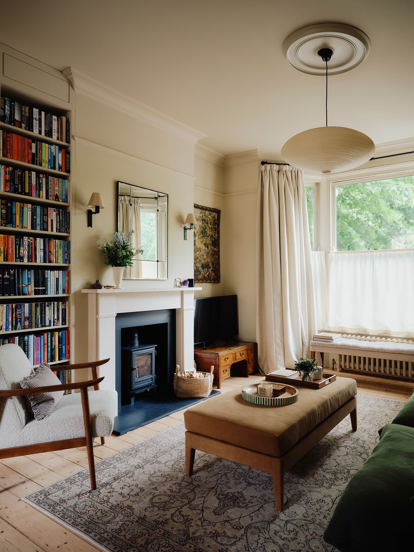 Image may contain Lamp Plant Home Decor Chair Furniture Rug Computer Hardware Electronics Hardware and Monitor