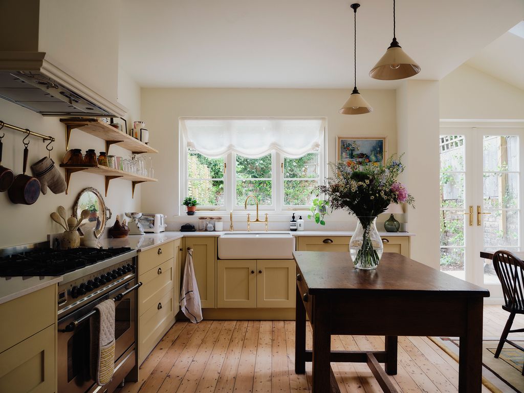 Image may contain Indoors Kitchen Chair Furniture Interior Design Cooktop Sink Plant Desk Table and Lamp