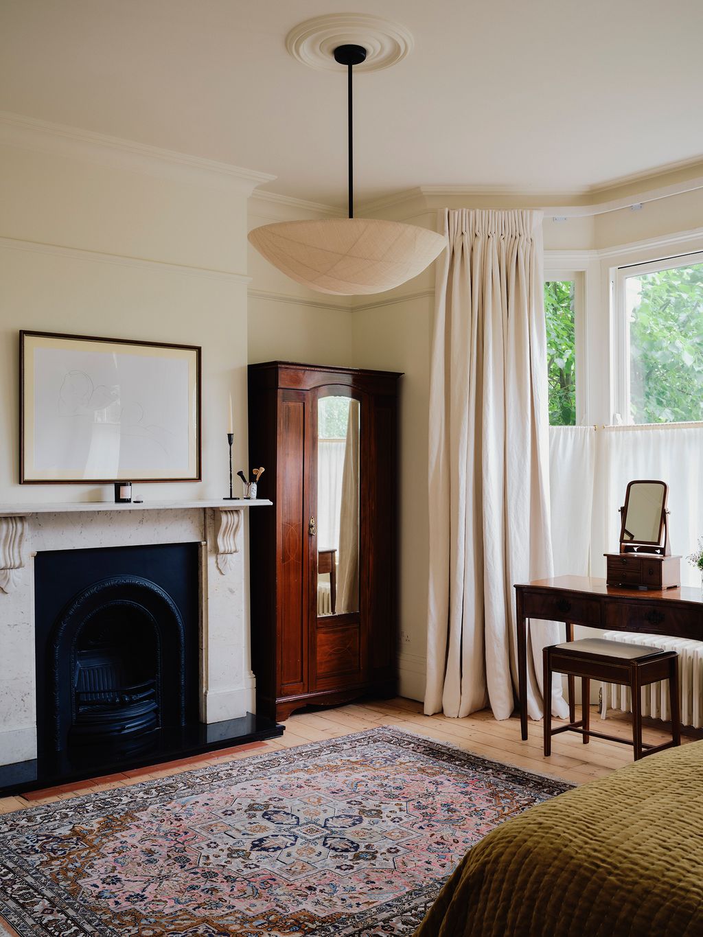 Image may contain Corner Home Decor Desk Furniture Table Rug Lamp Fireplace Indoors Interior Design and Chair