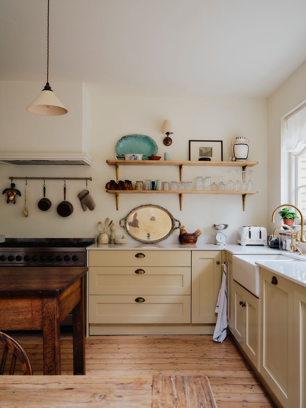 Image may contain Indoors Interior Design Lamp Kitchen Cooktop Art Painting Chair Furniture Plant and Sink