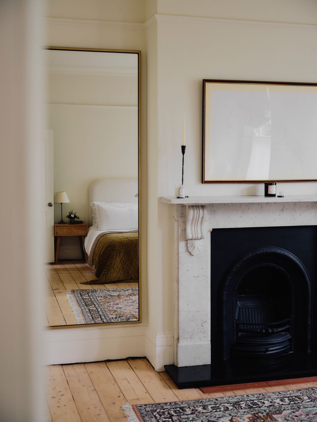 Image may contain Indoors Interior Design Fireplace Lamp Floor Flooring Bed Furniture Hearth Home Decor and Rug