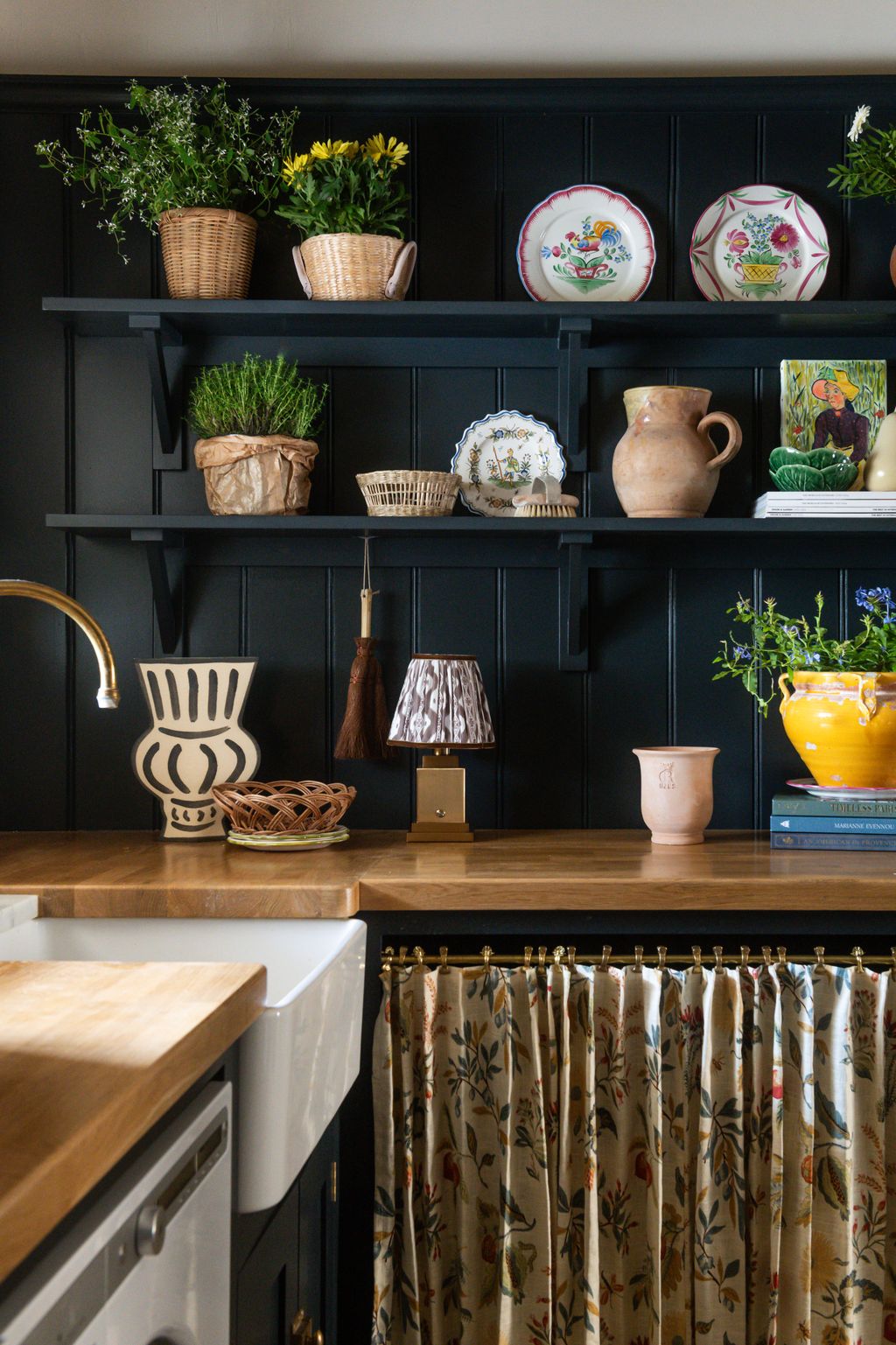 Image may contain Lamp Indoors Interior Design Plant Plate Shelf Kitchen Person Pottery and Furniture