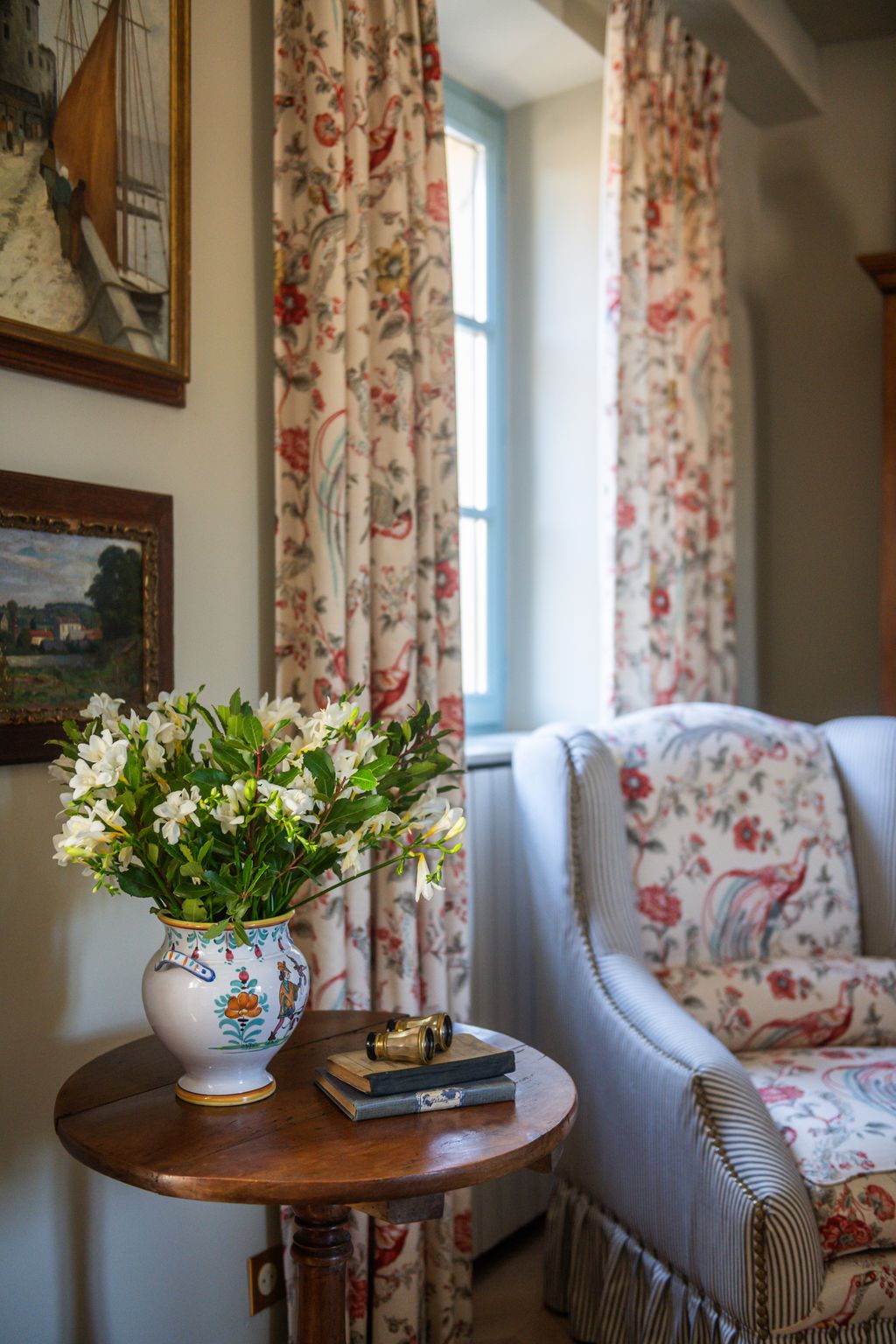 Image may contain Architecture Building Furniture Indoors Living Room Room Flower Flower Arrangement Plant and Book