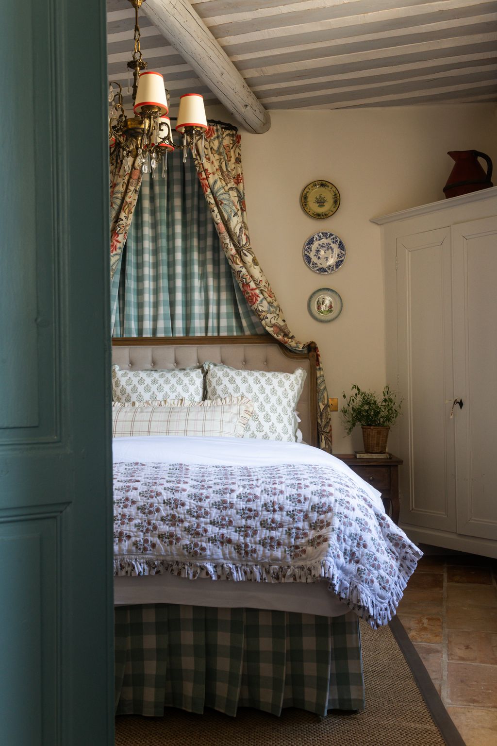 Image may contain Indoors Interior Design Plant Bed Furniture Plate Chandelier Lamp Bedroom Room and Home Decor