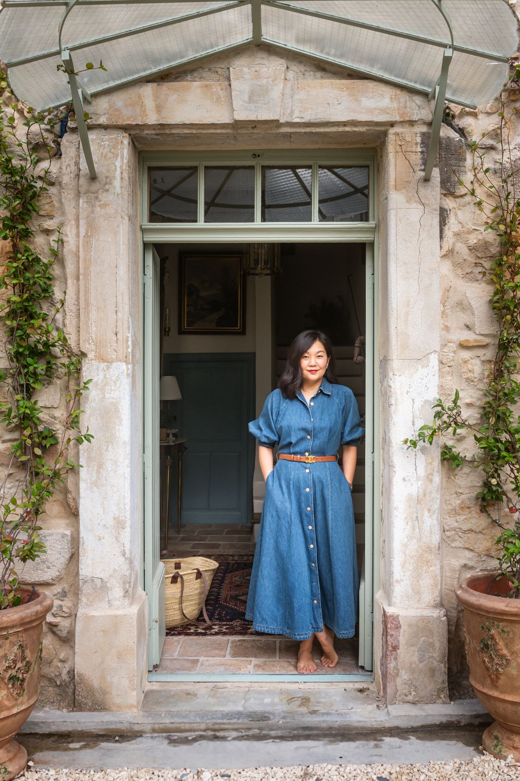 Image may contain Momo Kodama Clothing Pants Plant Potted Plant Herbal Herbs Adult Person Dress and Jeans