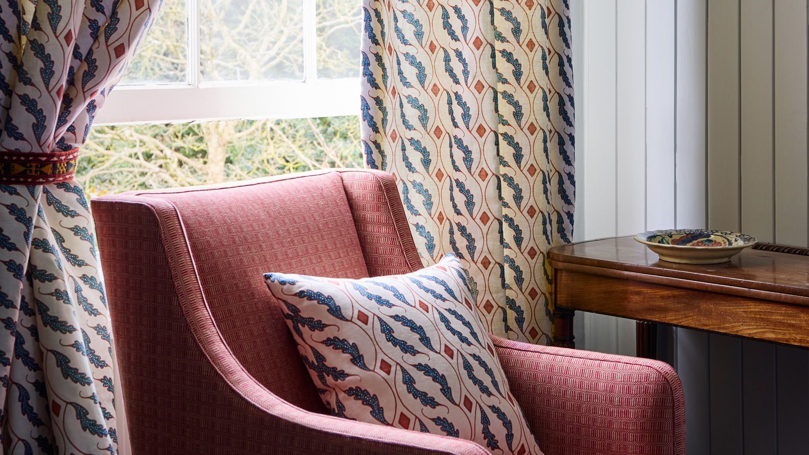 Image may contain: Cushion, Home Decor, Furniture, Person, Chair, Pillow, Plate, Couch, and Armchair