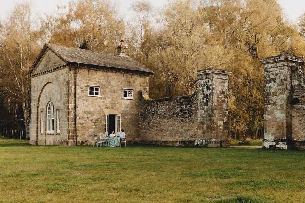 Image may contain Architecture Building Monastery Grass Plant Cottage House Housing Person Arch and Gothic Arch