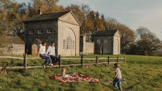 Image may contain Architecture Building Outdoors Shelter Grass Plant Person Adult Clothing Pants and Lawn