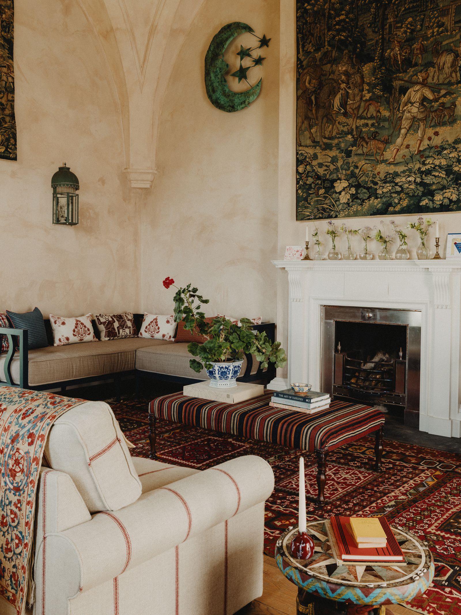 Image may contain Home Decor Lamp Rug Couch Furniture Architecture Building Indoors Living Room Room and Candle