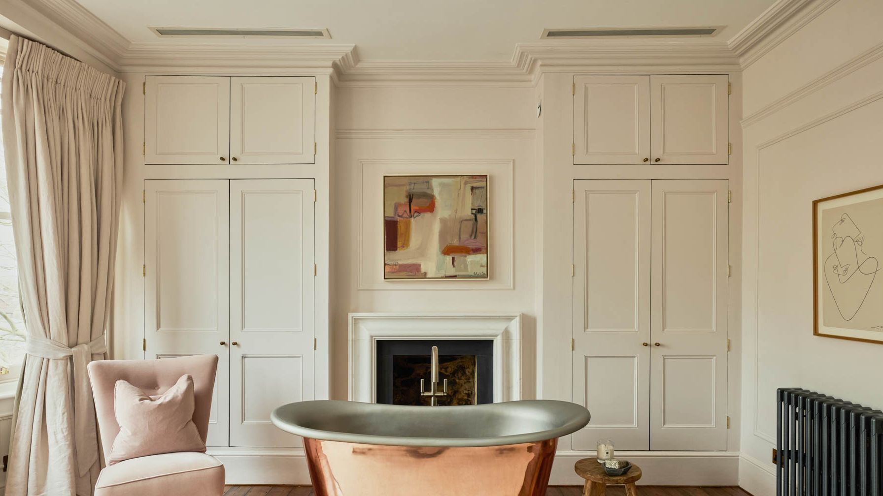 Image may contain: Indoors, Interior Design, Fireplace, Bathing, Bathtub, Person, Tub, Home Decor, Art, Painting, and Chair