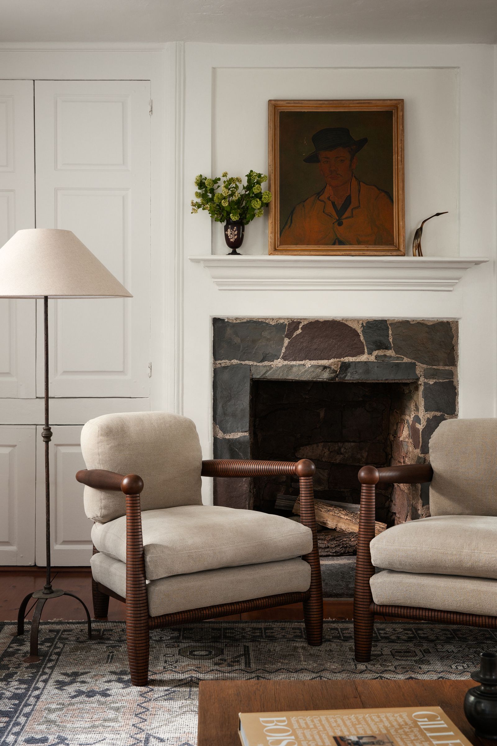 Image may contain Fireplace Indoors Lamp Chair Furniture Book Publication Home Decor Rug Art and Painting