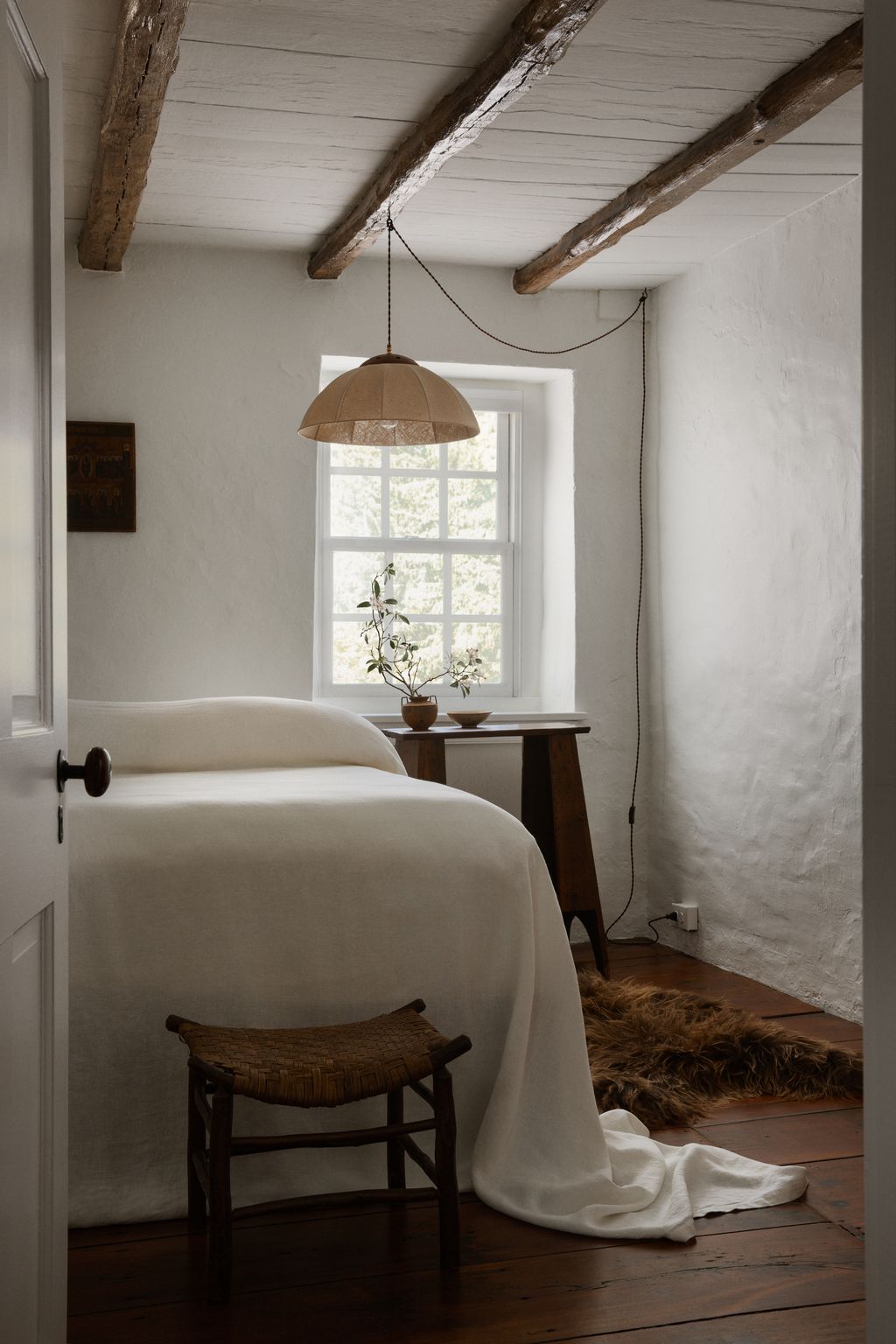 Image may contain Indoors Interior Design Lamp Home Decor Rug Bed Furniture Window and Floor