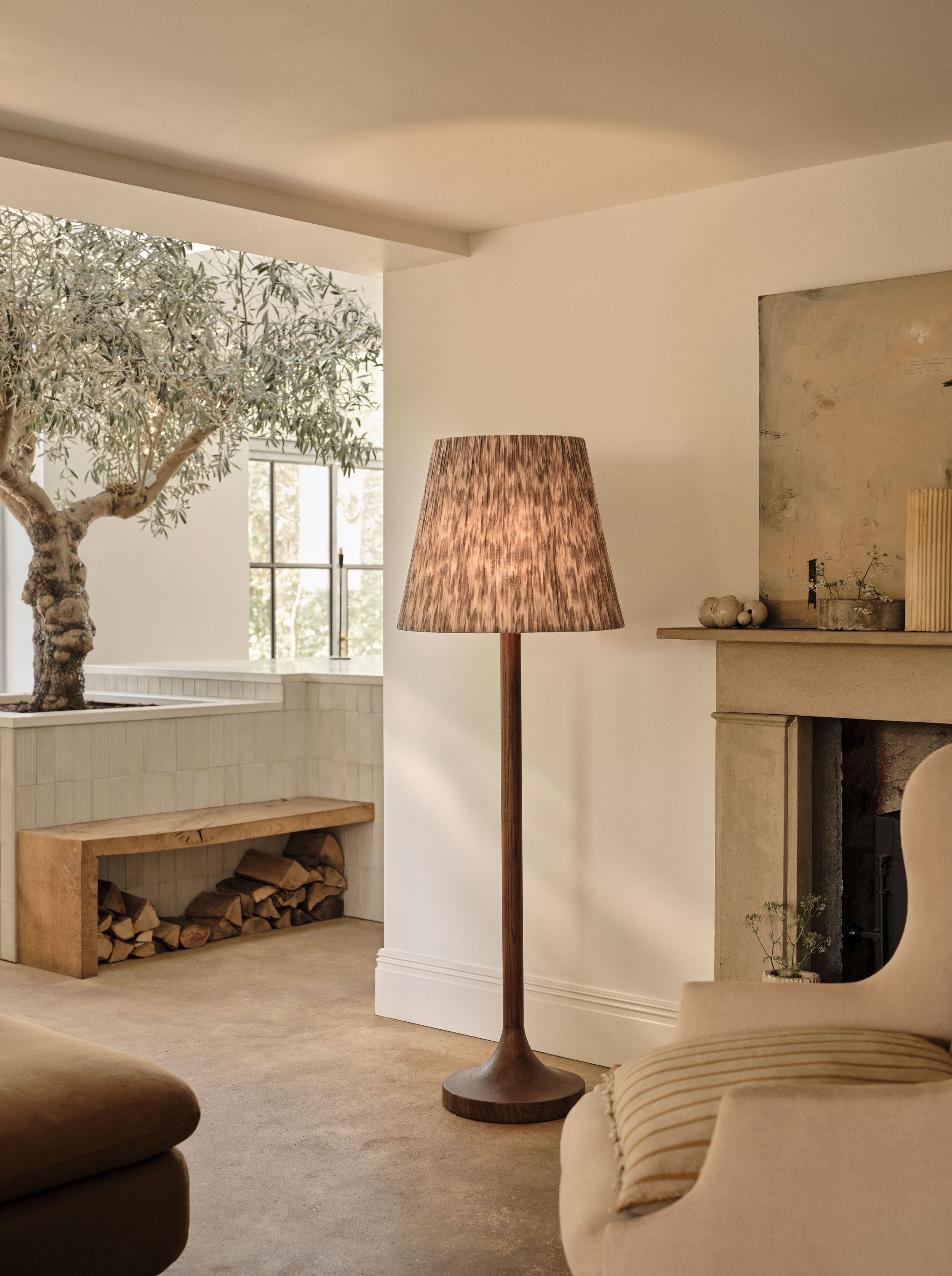 Image may contain: Lamp, Plant, Floor Lamp, Couch, Furniture, and Bench